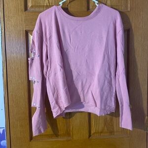 Long sleeve pink crop top with slits in the sleeves and gems